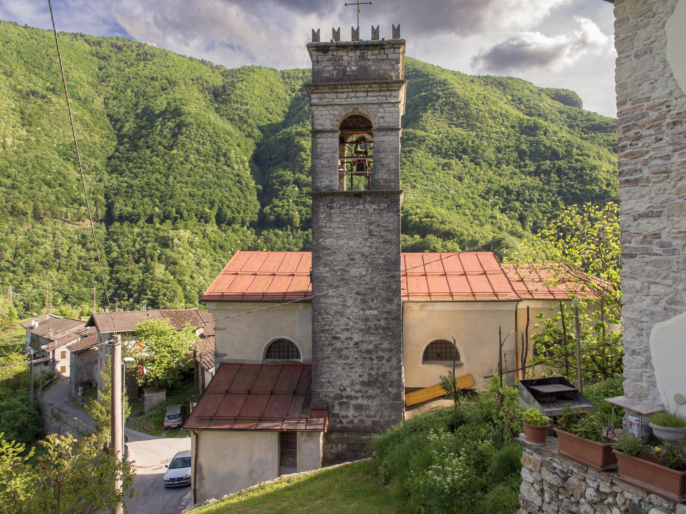 View of the campanile of the church of Incino with the village and Monte Grappa in the background