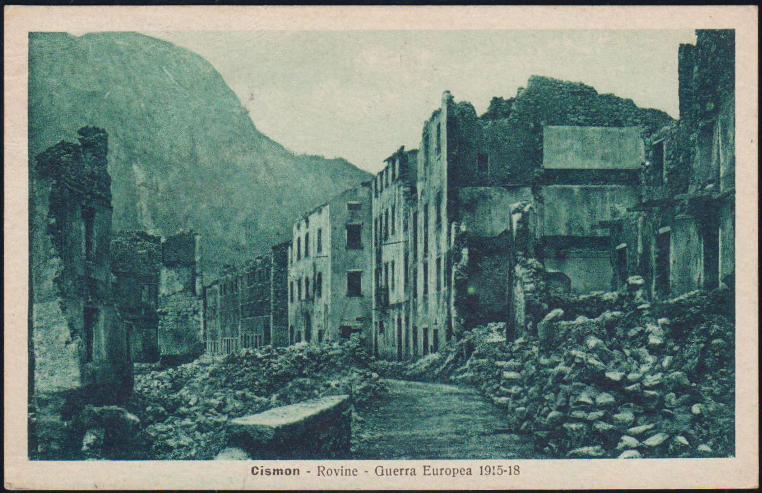 Postcard of the shells of buildings along Cismon's main street after World War I