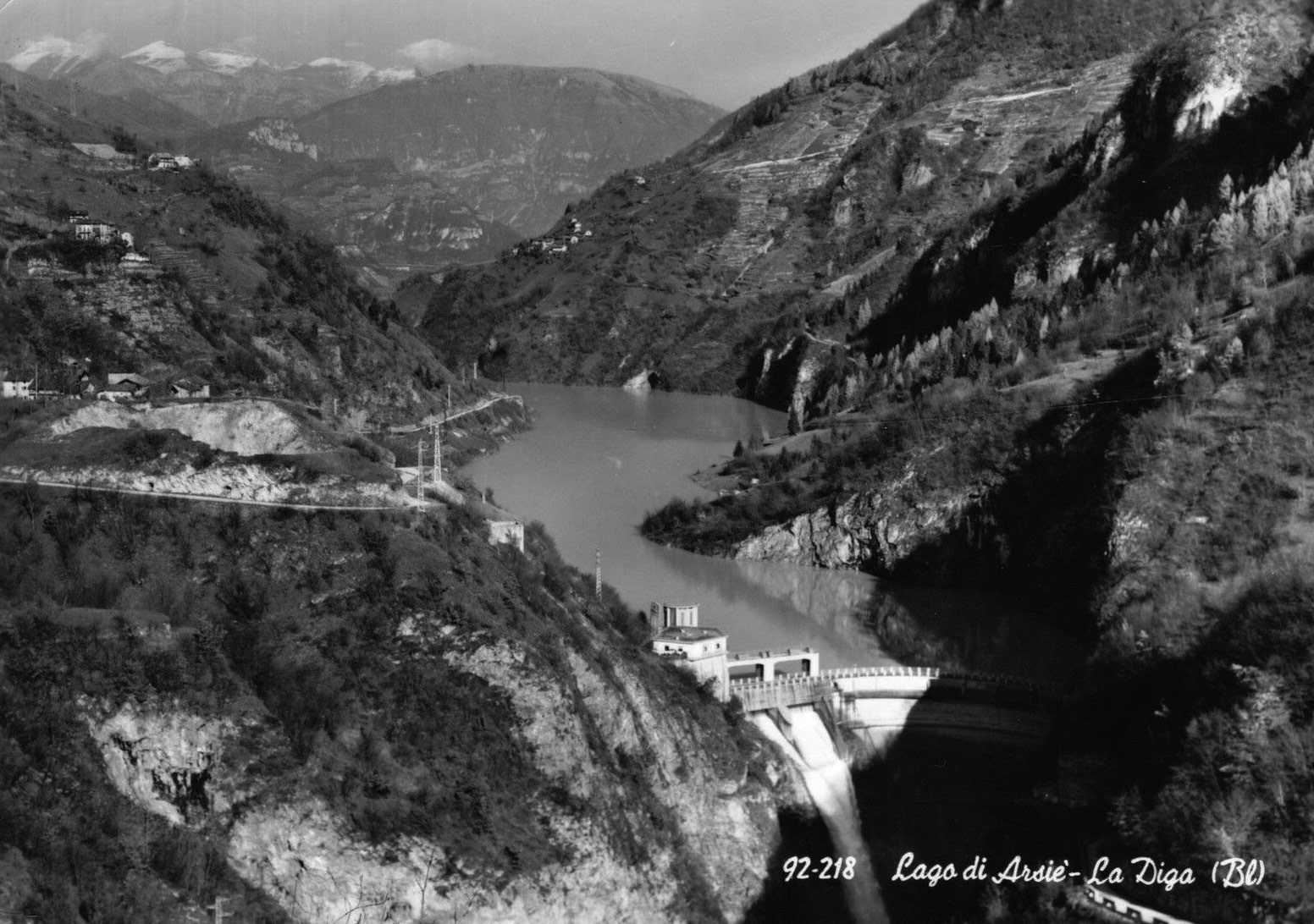 Black and white view of dam and lake