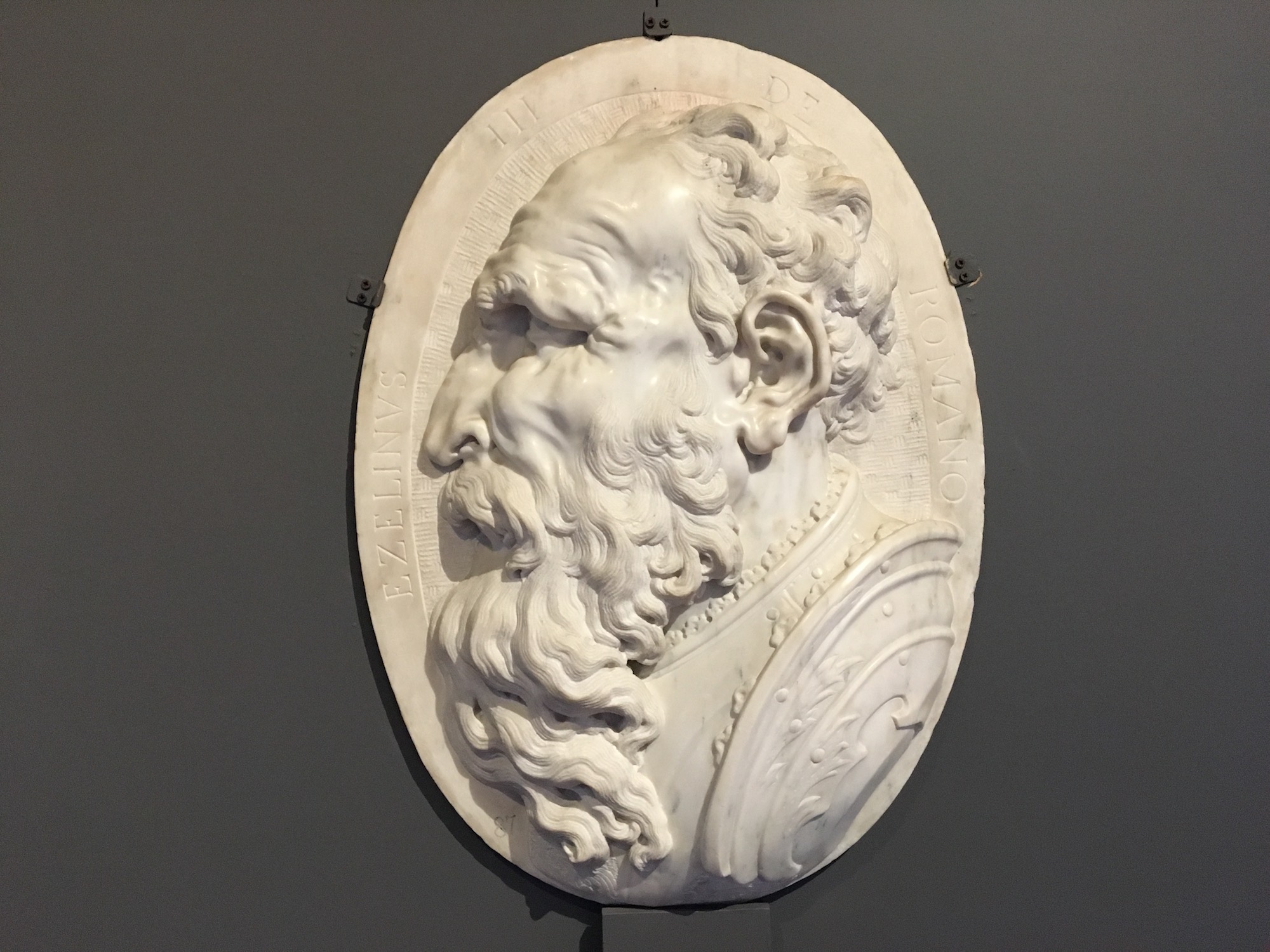 High-relief marble medallion portrait of Ezzelino III da Romano. He looks mean.