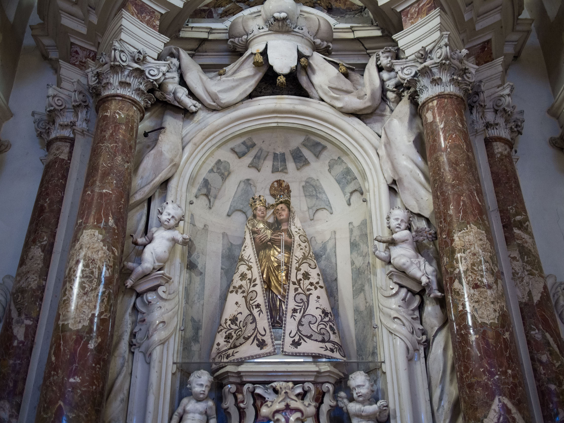 The original statue of the Madonna del Pedancino that had been swept downstream during a flood in 1748, seen in the church of San Marco in Cismon del Grappa