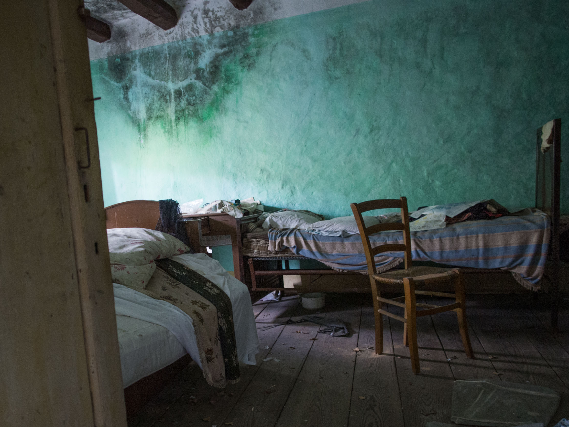 A bedroom in an abandoned apartment in the district of Martinati, next to Incino