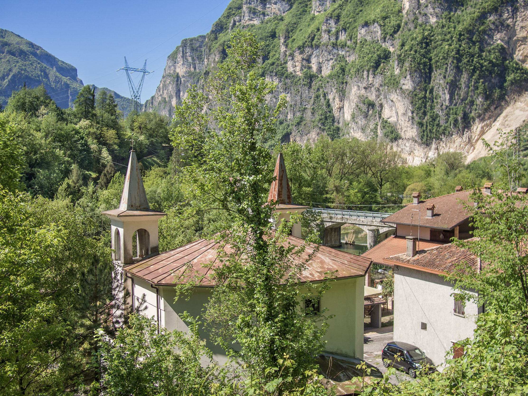 View of the back of Pedancino's chapel, looking toward Cismon with cliffs in the background