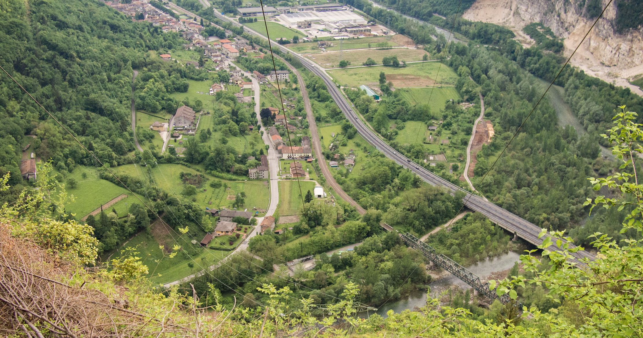 View toward Cismon and the Brenta River Valley with power lines. The Cismon River can be seen at bottom