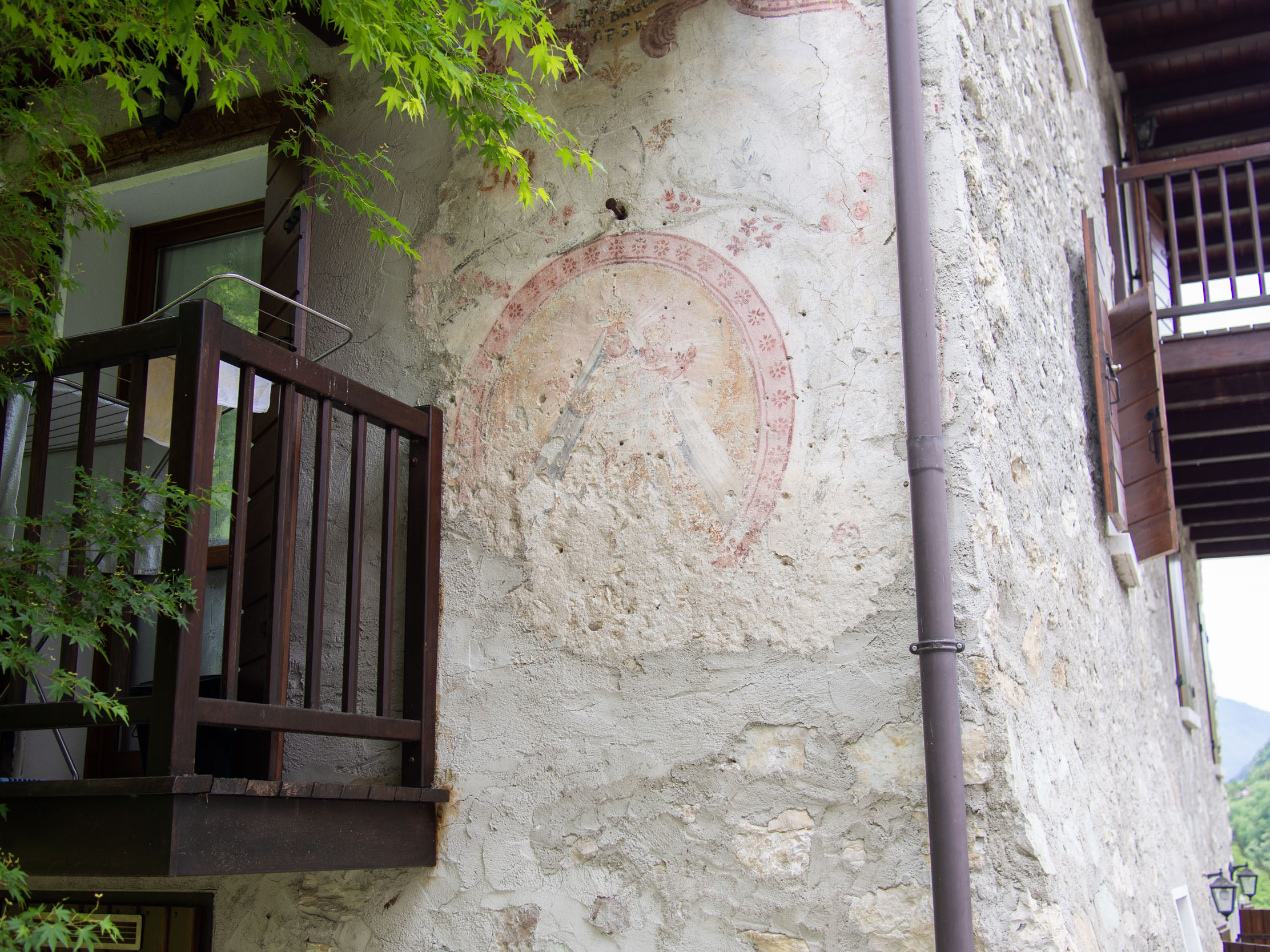 Faded fresco of the Madonna on a building in the hamlet of Tanisoi, by Incino